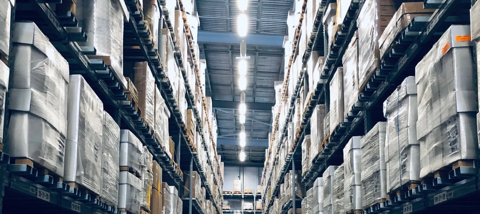 Warehouse aisle with racked inventory and stored cargo
